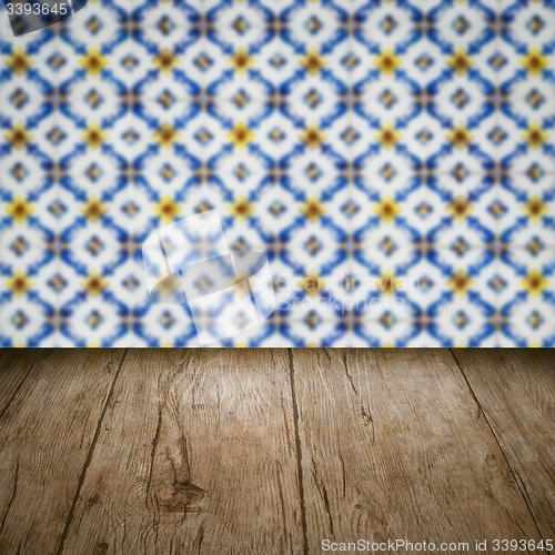 Image of Wood table top and blur vintage ceramic tile pattern wall