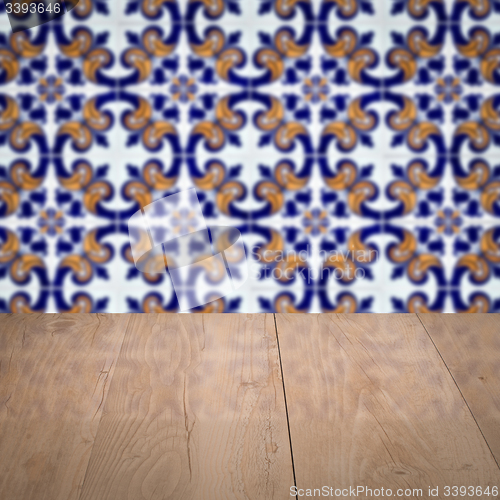 Image of Wood table top and blur vintage ceramic tile pattern wall