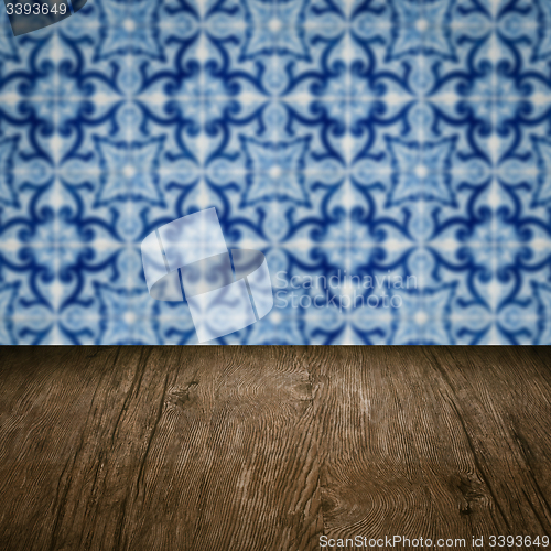 Image of Wood table top and blur vintage ceramic tile pattern wall