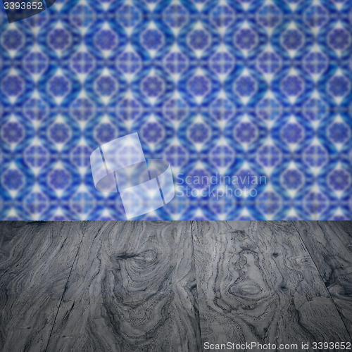 Image of Wood table top and blur vintage ceramic tile pattern wall