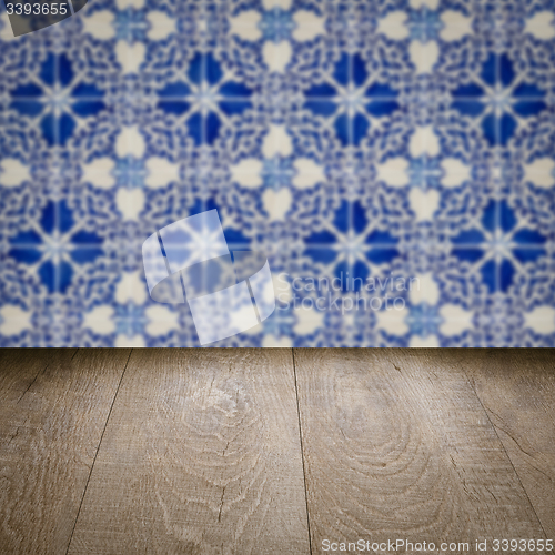 Image of Wood table top and blur vintage ceramic tile pattern wall