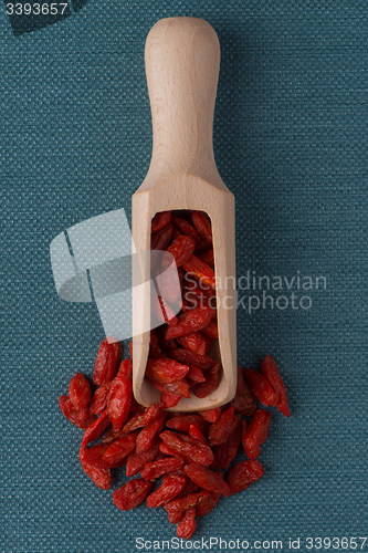 Image of Wooden scoop with dry red goji berries