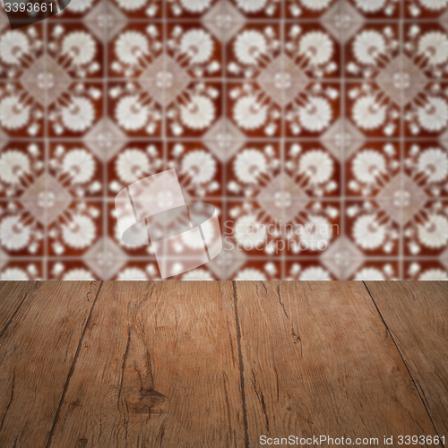 Image of Wood table top and blur vintage ceramic tile pattern wall