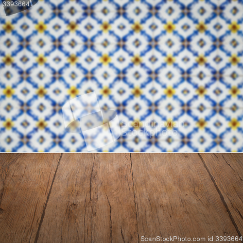 Image of Wood table top and blur vintage ceramic tile pattern wall