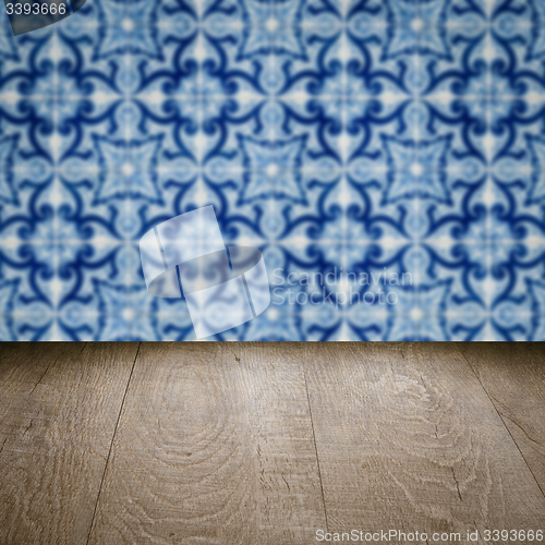 Image of Wood table top and blur vintage ceramic tile pattern wall