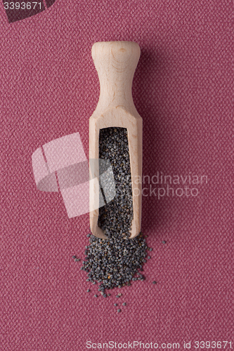 Image of Wooden scoop with poppy seeds