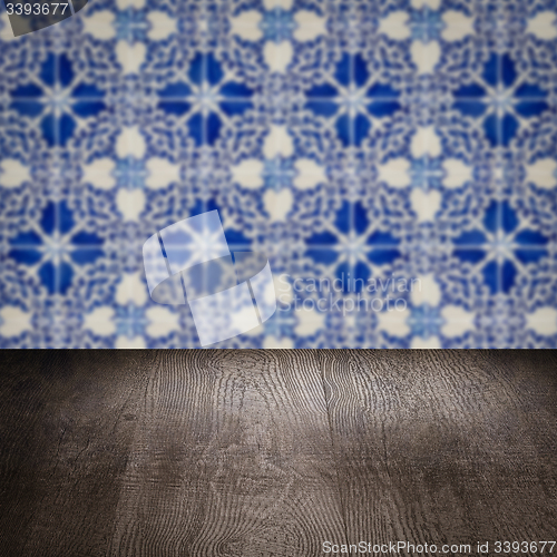 Image of Wood table top and blur vintage ceramic tile pattern wall