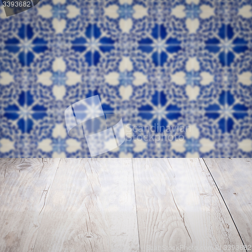 Image of Wood table top and blur vintage ceramic tile pattern wall