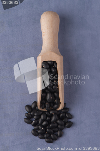 Image of Wooden scoop with black beans