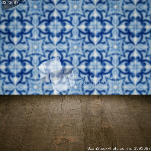 Image of Wood table top and blur vintage ceramic tile pattern wall