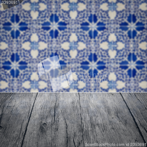 Image of Wood table top and blur vintage ceramic tile pattern wall