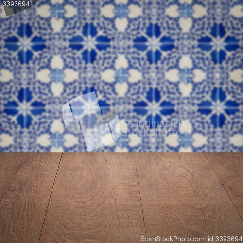 Image of Wood table top and blur vintage ceramic tile pattern wall