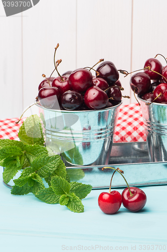 Image of Cherries in blue wooden table