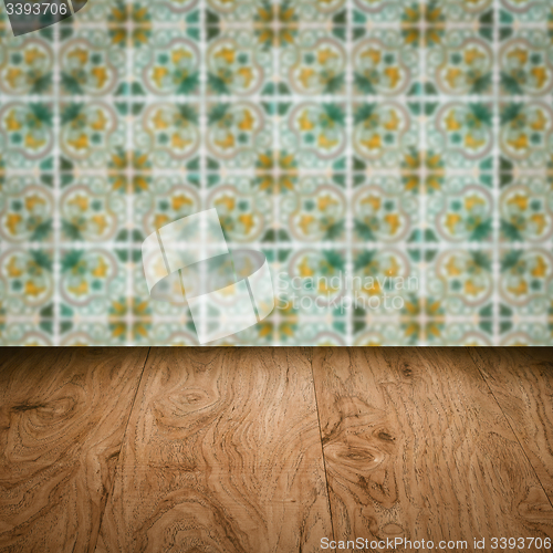 Image of Wood table top and blur vintage ceramic tile pattern wall