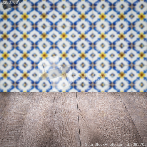 Image of Wood table top and blur vintage ceramic tile pattern wall