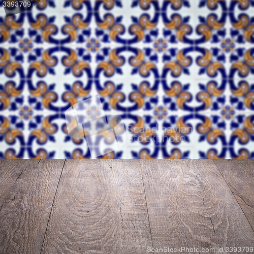 Image of Wood table top and blur vintage ceramic tile pattern wall