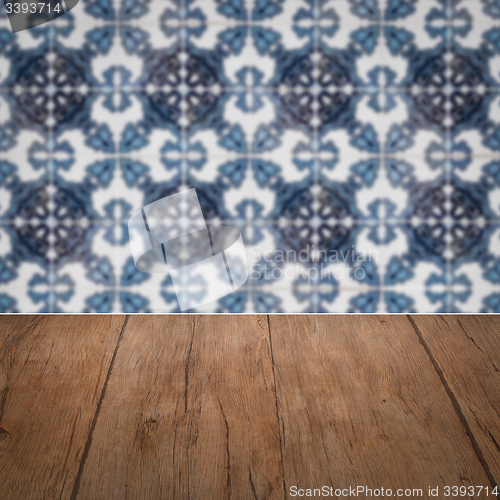 Image of Wood table top and blur vintage ceramic tile pattern wall