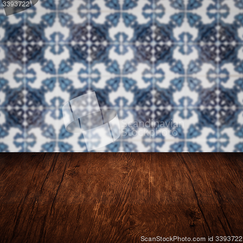 Image of Wood table top and blur vintage ceramic tile pattern wall