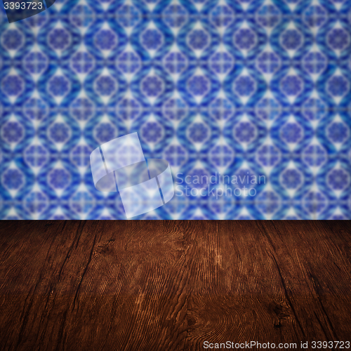 Image of Wood table top and blur vintage ceramic tile pattern wall