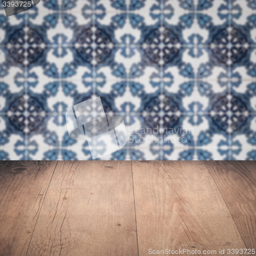 Image of Wood table top and blur vintage ceramic tile pattern wall