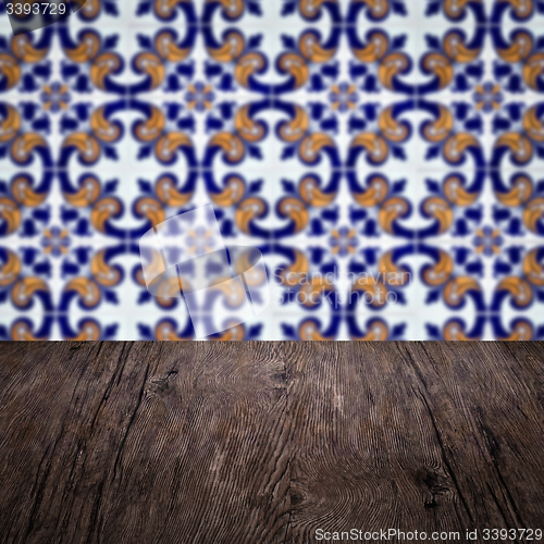 Image of Wood table top and blur vintage ceramic tile pattern wall