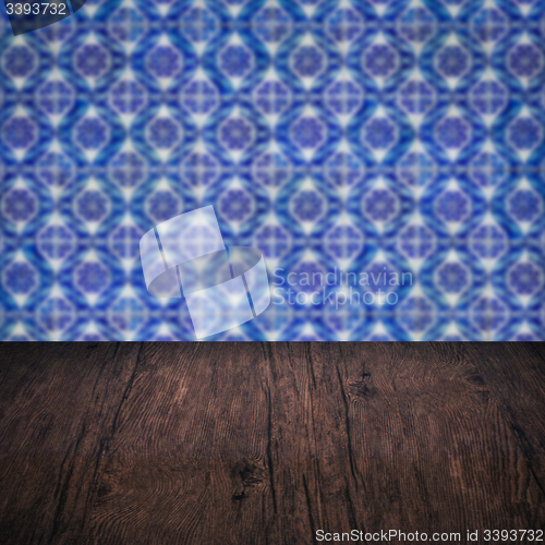 Image of Wood table top and blur vintage ceramic tile pattern wall