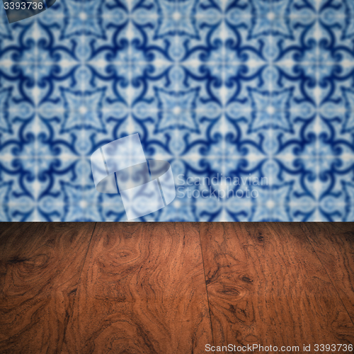 Image of Wood table top and blur vintage ceramic tile pattern wall