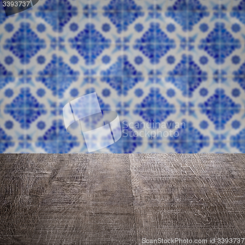Image of Wood table top and blur vintage ceramic tile pattern wall