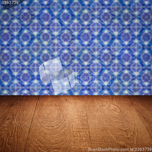 Image of Wood table top and blur vintage ceramic tile pattern wall