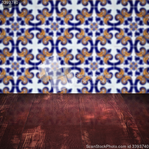 Image of Wood table top and blur vintage ceramic tile pattern wall