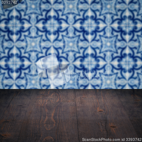 Image of Wood table top and blur vintage ceramic tile pattern wall