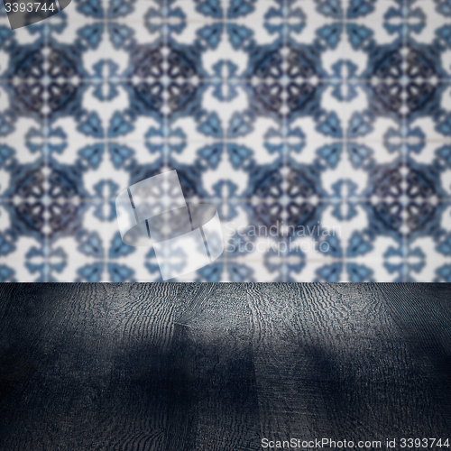 Image of Wood table top and blur vintage ceramic tile pattern wall