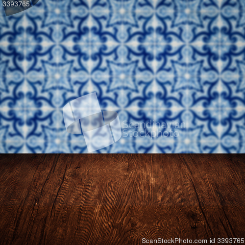 Image of Wood table top and blur vintage ceramic tile pattern wall