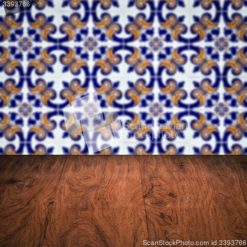 Image of Wood table top and blur vintage ceramic tile pattern wall
