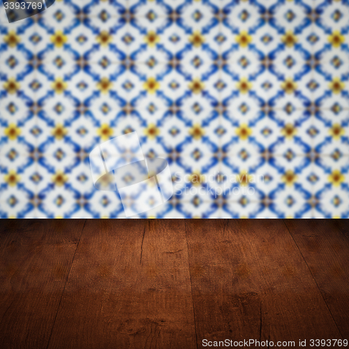 Image of Wood table top and blur vintage ceramic tile pattern wall