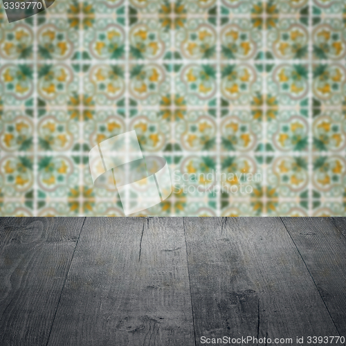 Image of Wood table top and blur vintage ceramic tile pattern wall