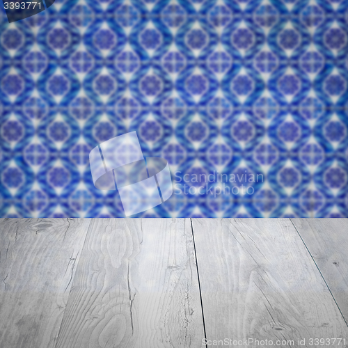 Image of Wood table top and blur vintage ceramic tile pattern wall