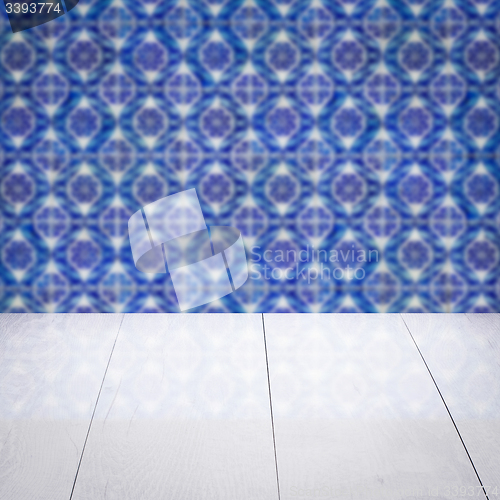Image of Wood table top and blur vintage ceramic tile pattern wall