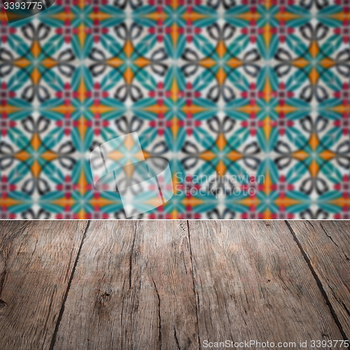 Image of Wood table top and blur vintage ceramic tile pattern wall