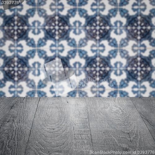 Image of Wood table top and blur vintage ceramic tile pattern wall