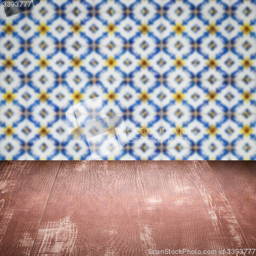 Image of Wood table top and blur vintage ceramic tile pattern wall