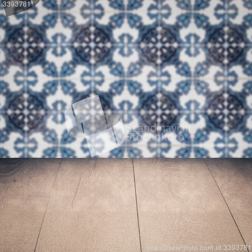 Image of Wood table top and blur vintage ceramic tile pattern wall