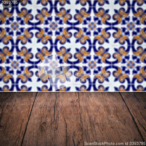 Image of Wood table top and blur vintage ceramic tile pattern wall