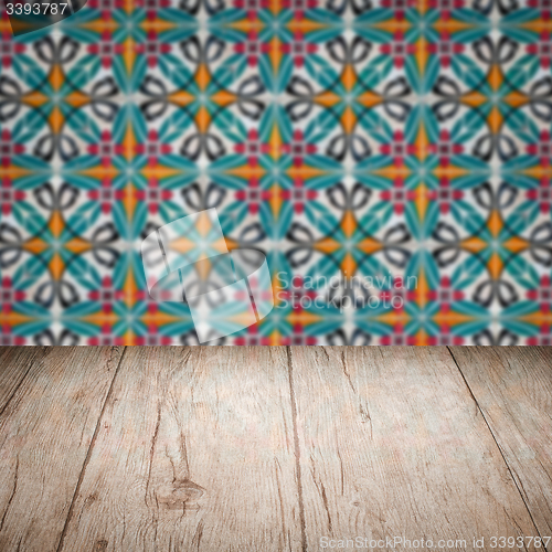 Image of Wood table top and blur vintage ceramic tile pattern wall