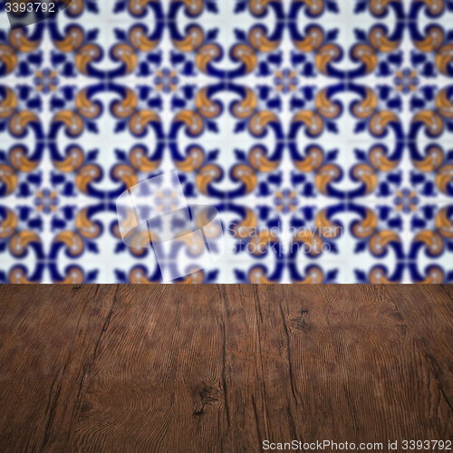 Image of Wood table top and blur vintage ceramic tile pattern wall