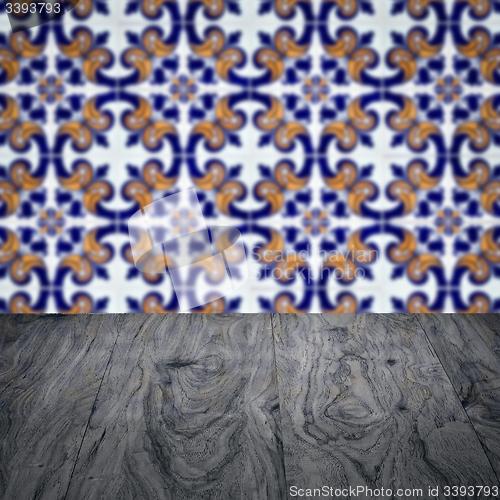 Image of Wood table top and blur vintage ceramic tile pattern wall