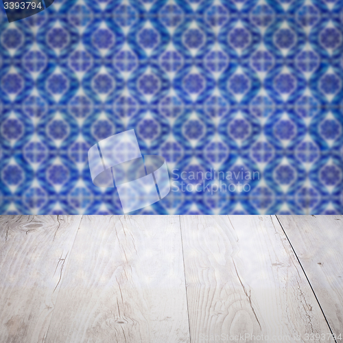 Image of Wood table top and blur vintage ceramic tile pattern wall