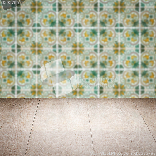 Image of Wood table top and blur vintage ceramic tile pattern wall