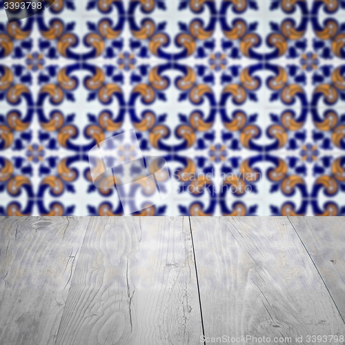 Image of Wood table top and blur vintage ceramic tile pattern wall
