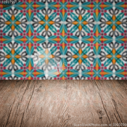 Image of Wood table top and blur vintage ceramic tile pattern wall